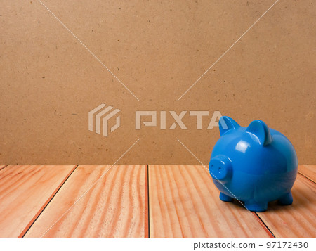 The piggy bank on wood table for earn or saving concept 97172430