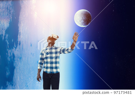 Man wearing virtual reality goggles 97173481