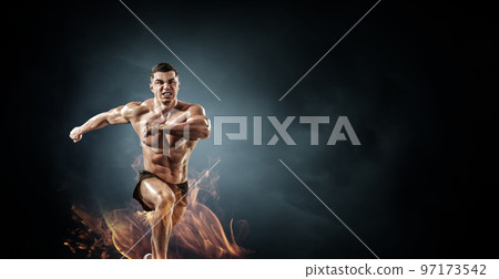 Male runner against dark background Male runner against dark background 97173542