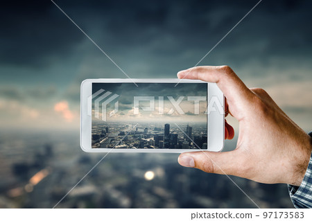 Hand holding smartphone mobile . Mixed media 97173583