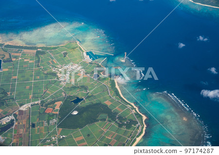 A southern island with bright emerald green coral reefs A southern island with bright emerald green coral reefs 97174287