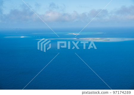 An uninhabited island where the emerald green sea shines brightly and vividly An uninhabited island where the emerald green sea shines brightly and vividly 97174289