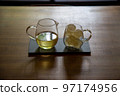 Green tea in a pot and a glass with ice 97174956