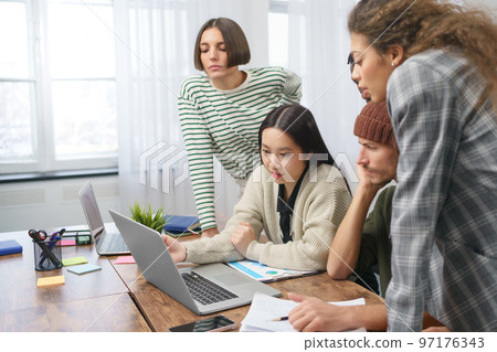 business team working at a table in a coworking center . 97176343
