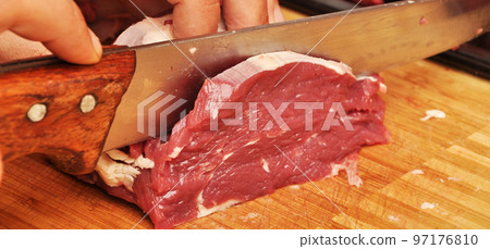 Clean very fresh red raw cow meat and a sharp knife 97176810