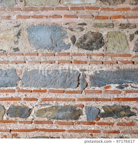 Sturdy blue and gray cut stone and red brick wall seamless lined up 97176817