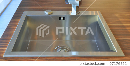Interior of modern kitchen and stainless steel sink, tap and drain 97176831