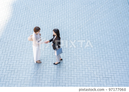 Business woman shaking hands 97177068