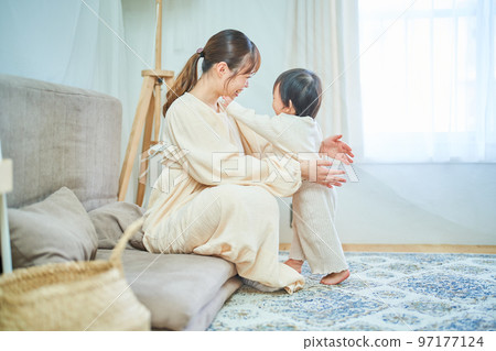 Parent and child hugging in the room 97177124