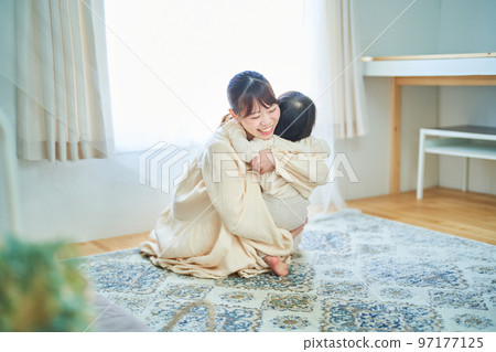 Parent and child hugging in the room 97177125