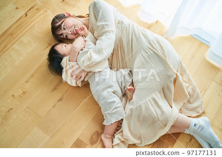 Parent and child hugging in the room Parent and child hugging in the room 97177131