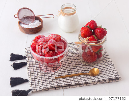Tasty fresh strawberries in a glass bowl with creme fraiche 97177162