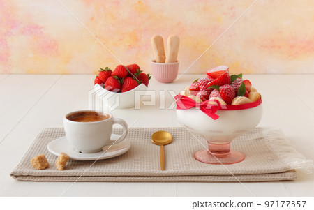 Charlotte, French dessert with strawberries tied up with a scarlet ribbon, easy and fast dessert made into a glass. 97177357