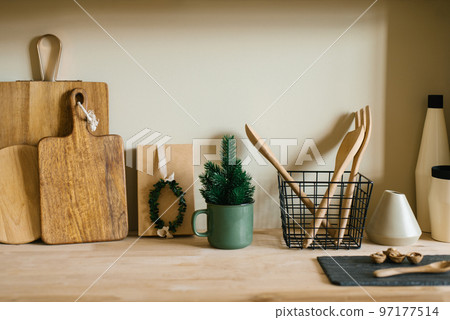 Scandinavian style kitchen utensils. Wooden cutting boards, wooden spoons and shovels. tree in a pot. Christmas decor 97177514