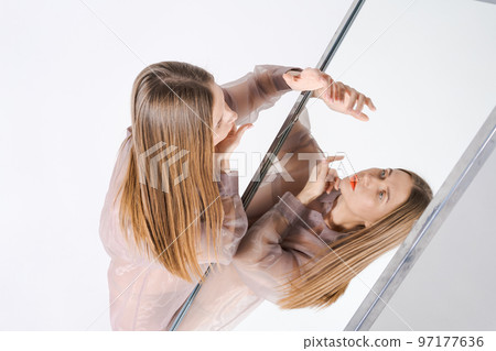 Self-realization portrait woman in mirror image. Unusual strange pretty woman 97177636