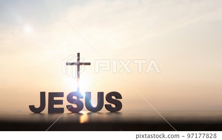 The brightly rising New Year's sunrise and the holy cross of Jesus Christ and JESUS 97177828