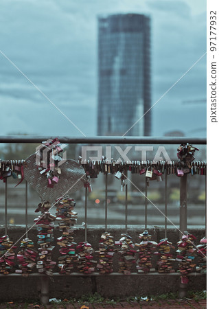 Vertical shot of many love locks on the railing of the Hohenzollern Bridge in Cologne, Germany Vertical shot of many love locks on the railing of the Hohenzollern Bridge in Cologne, Germany 97177932