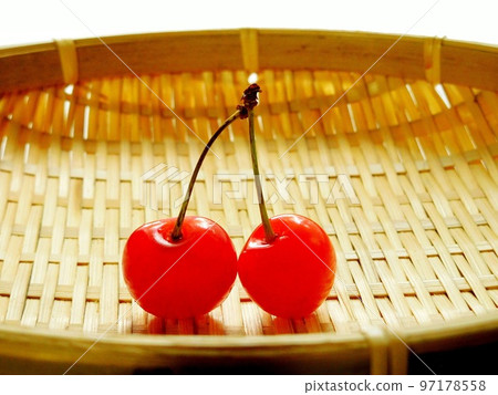 Place 2 cherries in a colander 97178558