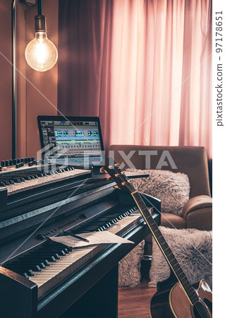 Electronic piano and guitar in room interior. 97178651
