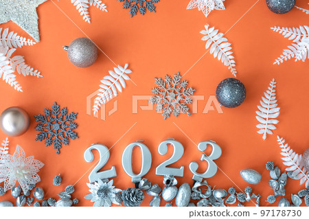 Flat lay, orange Christmas background with numbers 2023. Flat lay, orange Christmas background with numbers 2023. 97178730