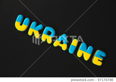 The word Ukraine on a black background, made with handmade gingerbread. 97178786