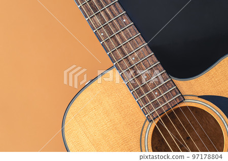 Acoustic guitar close-up on a colored background, flat lay. 97178804