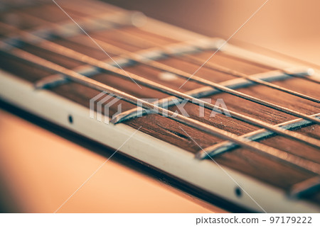 Guitar neck with a metal string, macro photography. 97179222