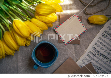 Vintage composition with a cup of tea, tulips and notes, flat lay. Vintage composition with a cup of tea, tulips and notes, flat lay. 97179423