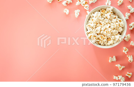 Popcorn plate on pink background, flat lay. 97179436
