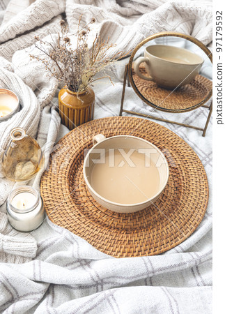 Cozy autumn composition with a cup of coffee and candles in bed. Cozy autumn composition with a cup of coffee and candles in bed. 97179592
