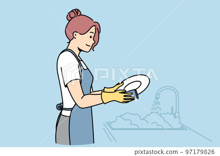 Woman washes plates in gloves, apron near sink. 97179826