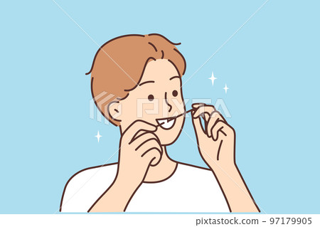 Young man cleaning teeth with dental floss  97179905