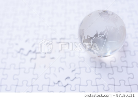 Globe on jigsaw puzzle last piece front bright 97180131