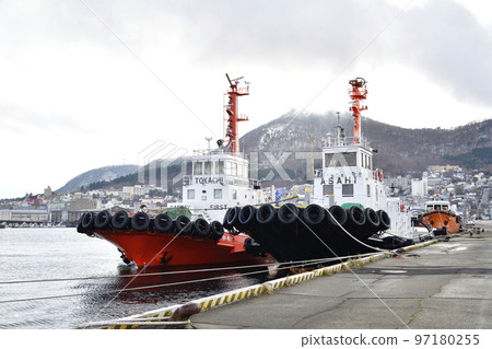 Photographing the scenery of a tugboat moored at Hakodate Port in Hakodate City, Hokkaido in winter 97180255