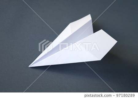 White paper plane origami isolated on a grey background 97180289
