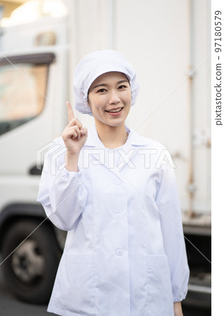 Young female food delivery driver (pointing pose) Young female food delivery driver (pointing pose) 97180579