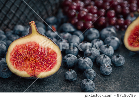 Close-up, figs in the cut among the berries. 97180789