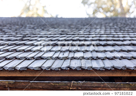 Close-up, the roof of a house made of wooden tiles. Close-up, the roof of a house made of wooden tiles. 97181022