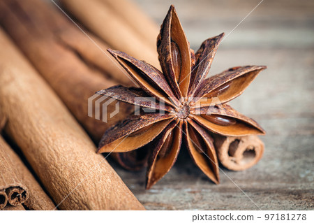 Star anise and cinnamon sticks close-up on a wooden background. 97181278