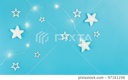 Blue Christmas background with garland and decorative stars, flat lay. Blue Christmas background with garland and decorative stars, flat lay. 97181298