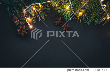 Christmas background with Christmas tree branches and garland, flat lay. 97181414