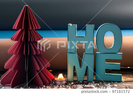 Cozy winter composition with decorative word home and paper christmas tree. Cozy winter composition with decorative word home and paper christmas tree. 97181572