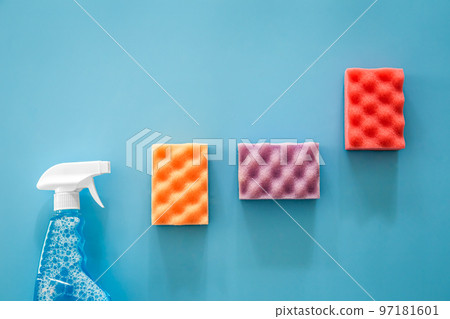 Glass cleaner spray and sponge on blue background, flat lay. Glass cleaner spray and sponge on blue background, flat lay. 97181601