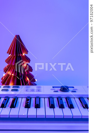 Christmas background with midi keyboard and holiday decor with neon lights. 97182004