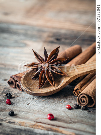 Close-up, star anise and cinnamon sticks on a wooden background, macro shot. 97182041