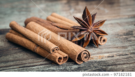 Star anise and cinnamon sticks close-up on a wooden background. Star anise and cinnamon sticks close-up on a wooden background. 97182181