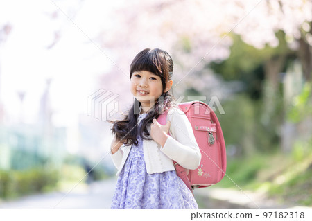 Girls carrying a school bag 97182318