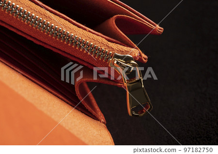 Part of a leather wallet and purse on a black background. Part of a leather wallet and purse on a black background. 97182750