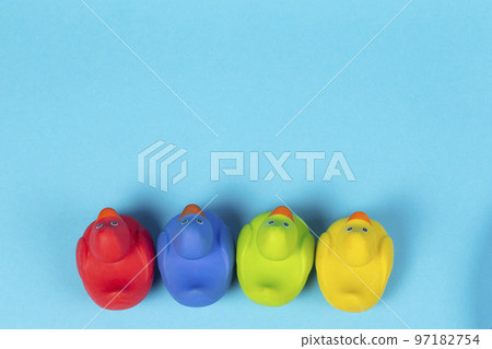 Multi-colored rubber ducks photographed from above on a blue background. Multi-colored rubber ducks photographed from above on a blue background. 97182754