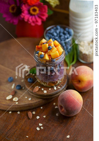 Healthy blueberries and raspberries parfait in mason jars, scene on dark rustic background 97183403